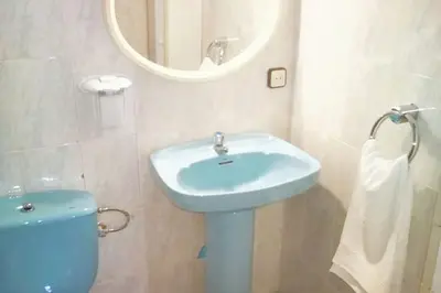 a bathroom with a blue sink and a mirror at Comfortable house near Esparreguera with city view in Esparreguera