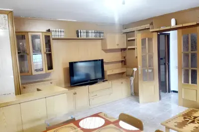 a living room with a flat screen tv on the wall at Comfortable house near Esparreguera with city view in Esparreguera