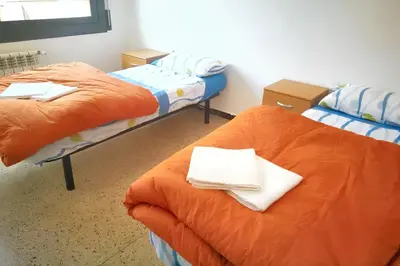 two beds in a room with towels on them at Comfortable house near Esparreguera with city view in Esparreguera
