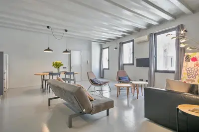 a living room with a couch and chairs and tables at My Address in Plaza Real in Barcelona
