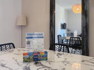 a box sitting on a table in front of a mirror at Stay U-nique Apartments Lepant in Barcelona