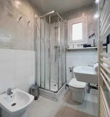 a bathroom with a shower and a toilet and a sink at Stay U-nique Apartments Lepant in Barcelona