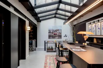 a bar with stools in a room with ceilings at Yurbban Ramblas Boutique Hotel in Barcelona
