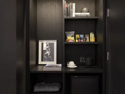 a book shelf with a picture of a woman on it at Yurbban Ramblas Boutique Hotel in Barcelona
