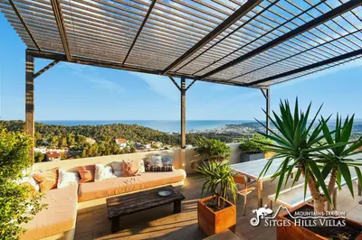 a living room with a couch and a table at Stunning Villa Ibizenca with private pool in Sitges in Sitges