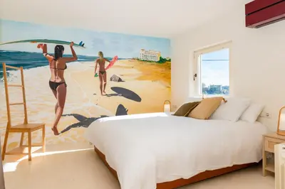 a bedroom with a mural of two women on the beach at Stunning Villa Ibizenca with private pool in Sitges in Sitges