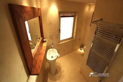 a bathroom with a sink and a mirror at Stunning Villa Ibizenca with private pool in Sitges in Sitges