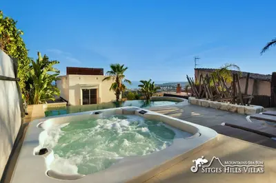a jacuzzi tub on the roof of a house at Stunning Villa Ibizenca with private pool in Sitges in Sitges