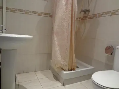 a bathroom with a shower and a toilet and a sink at Hostal Sant Carlo in Barcelona