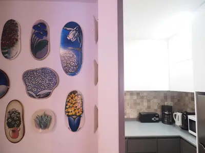 a wall with plates on a wall in a kitchen at Balcony View Apartment by Hello Homes Sitges in Sitges
