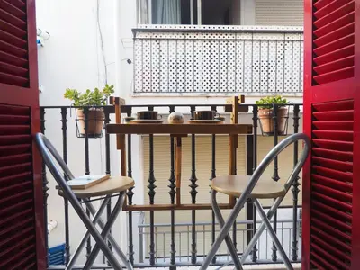 a table and two chairs on a balcony at Balcony View Apartment by Hello Homes Sitges in Sitges