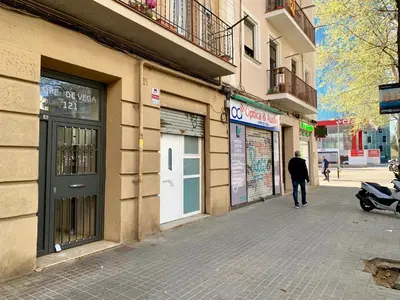 a man walking down a street next to a building at Charm Miró in Barcelona
