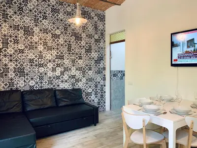 a living room with a couch and a table at Charm Miró in Barcelona
