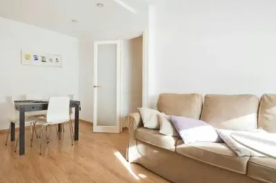 a living room with a couch and a table at Apartamento Noemi in Barcelona