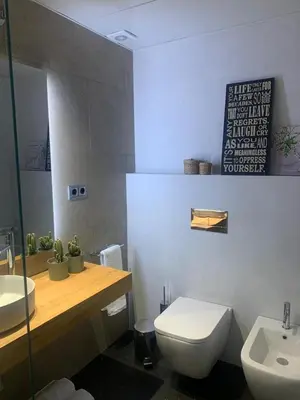 a white bedroom with a bed and a window at Casa Susana in Sitges