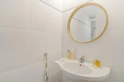 a white bathroom with a sink and a mirror at Sweett - Monumental in Barcelona