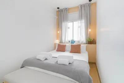 a bedroom with a large white bed with two pillows at Sweett - Monumental in Barcelona