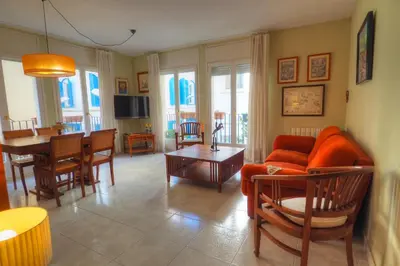 a living room with a couch and a table at Center Family Apartment by Hello Homes Sitges in Sitges