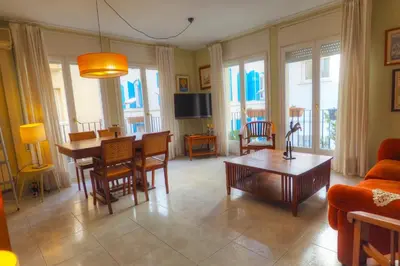 a living room with a couch and a table at Center Family Apartment by Hello Homes Sitges in Sitges