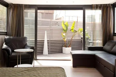 a living room with a couch and a chair at Dalia Ramblas in Barcelona