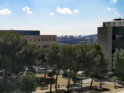 a view of a building with trees in front of it at Apartamento con Terraza, Balcón de Barcelona in Esplugues de Llobregat