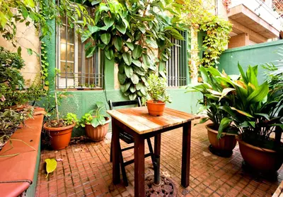 a patio with a wooden table and potted plants at Apartamento con Terraza, Balcón de Barcelona in Esplugues de Llobregat