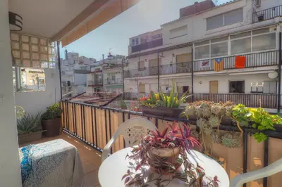 a balcony with a table and plants on a balcony at Orquidea Apartment by Hello Homes Sitges in Sitges