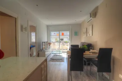 a kitchen and dining room with a table and chairs at Orquidea Apartment by Hello Homes Sitges in Sitges