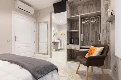 a bedroom with a bed and a chair at Urban Sabadell in Sabadell