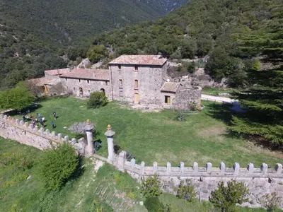 an old house on a hill with a fence at Masia de Vallforners in Tagamanent