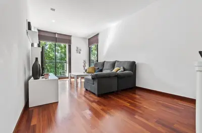 a living room with a couch and a table at Barcelona-Forum Apartments in Barcelona