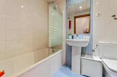 a bathroom with a sink and a toilet and a tub at Barcelona-Forum Apartments in Barcelona