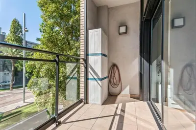 a balcony with a door on the side of a building at Barcelona-Forum Apartments in Barcelona