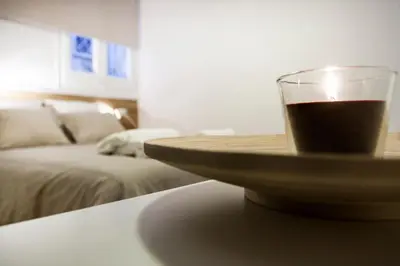 a glass of coffee on a table in a living room at Cien in Barcelona