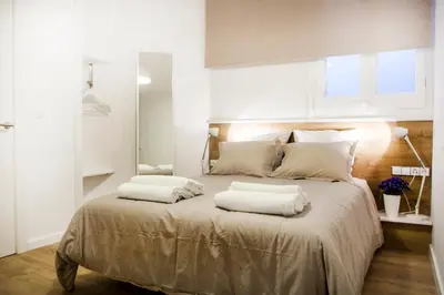 a bedroom with a large bed with two pillows on it at Cien in Barcelona