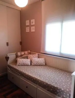 a bed in a room with a large window at Villa Mar & Natura Sitges in Canyelles