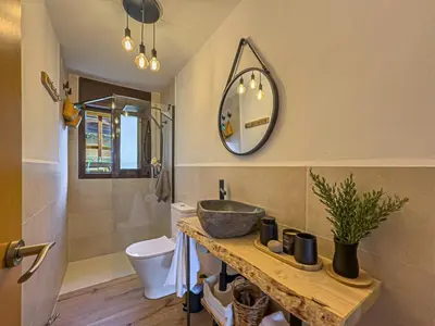 a bathroom with a sink and a mirror on the wall at Villa Mar & Natura Sitges in Canyelles
