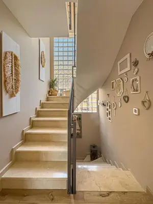 a staircase in a home with wooden floors at Villa Mar & Natura Sitges in Canyelles