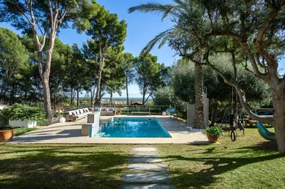 a swimming pool in a yard with trees at Villa Bella Vista in Castelldefels
