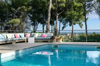 a swimming pool with a couch sitting on a deck next to at Villa Bella Vista in Castelldefels