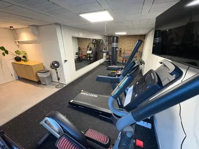 a row of treadmills in a gym with treadleys at Villa Bella Vista in Castelldefels