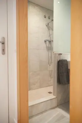 a bathroom with a shower with a glass door at SUN RAMBLA CATALUNYA GAUDI (Limpieza Desinfección) in Barcelona