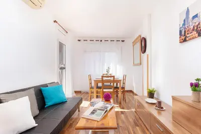 a living room with a couch and a table at Click&Flat Fira Gran Via in Hospitalet de Llobregat