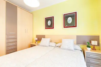 a bedroom with a large white bed with two pillows at Click&Flat Fira Gran Via in Hospitalet de Llobregat