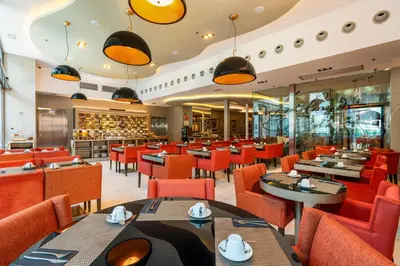 a dining room with tables and chairs and a restaurant at Hotel Indigo Barcelona - Plaza Catalunya 4Sup by IHG in Barcelona