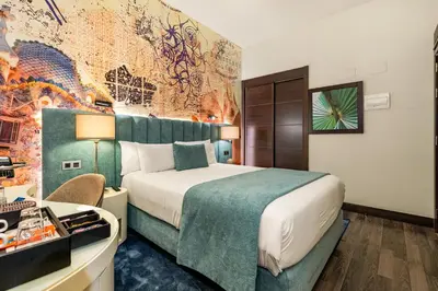 a hotel room with a bed and a map on the wall at Hotel Indigo Barcelona - Plaza Catalunya 4Sup by IHG in Barcelona
