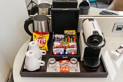 a tray with a coffee maker and some food at Hotel Indigo Barcelona - Plaza Catalunya 4Sup by IHG in Barcelona