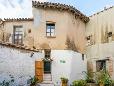 an old house with a door in a courtyard at Cottage in Pacs near St Marti Sarroca Castle in Pacs del Penedes
