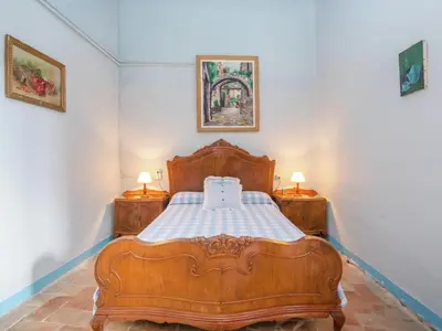 a bedroom with a wooden bed and two night stands at Cottage in Pacs near St Marti Sarroca Castle in Pacs del Penedes