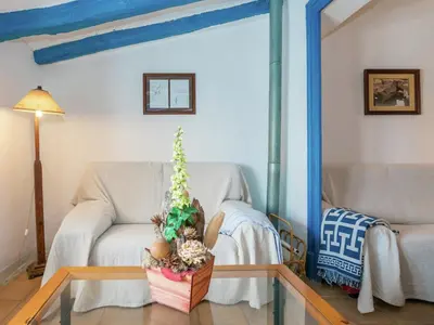 a living room with a couch and a table at Cottage in Pacs near St Marti Sarroca Castle in Pacs del Penedes